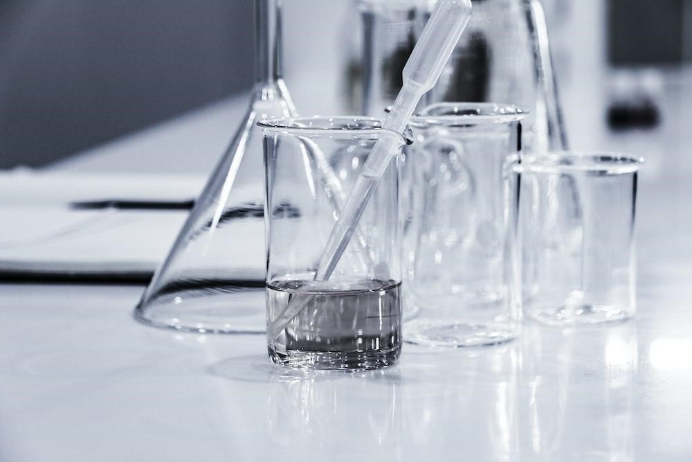Three transparent beakers placed on a tabletop